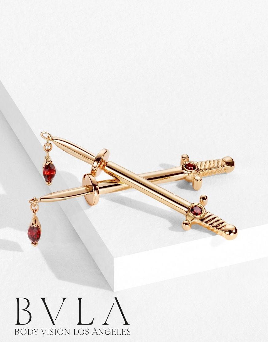 Gold and red earring on a white background with 'BVLA' branding.