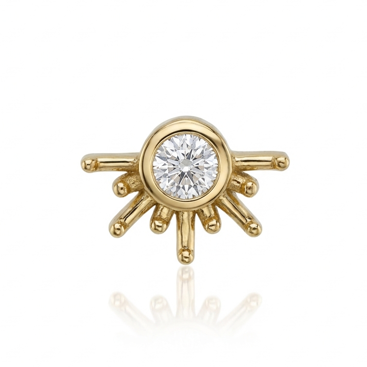 Gold earring with a central diamond on a white background