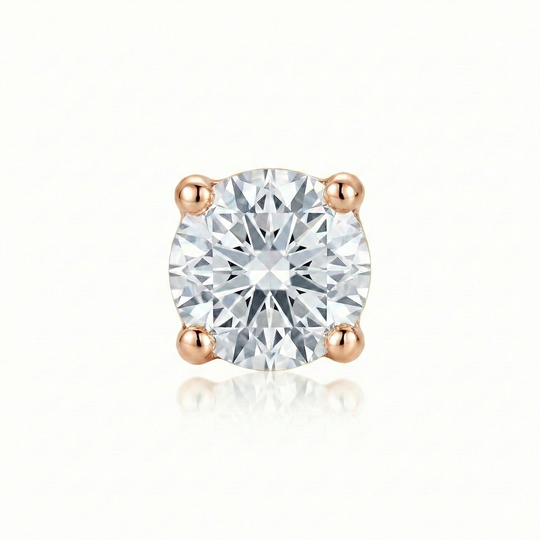 Single diamond earring with rose gold setting on a white background
