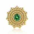 Gold earring with a green gemstone on a white background