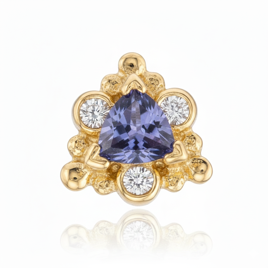 Gold earring with a purple gemstone and smaller diamonds on a white background