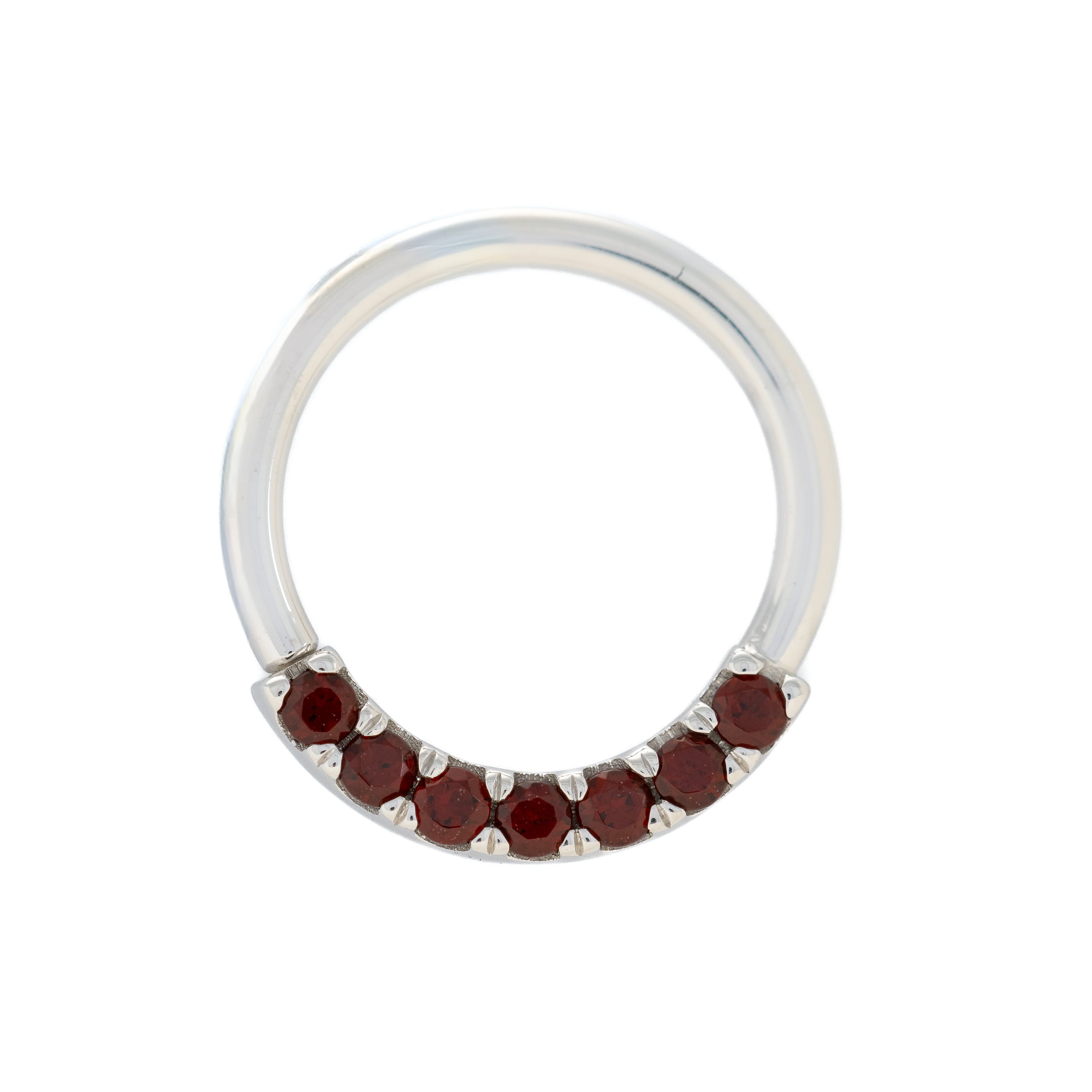 Silver ring with red gemstones on a white background