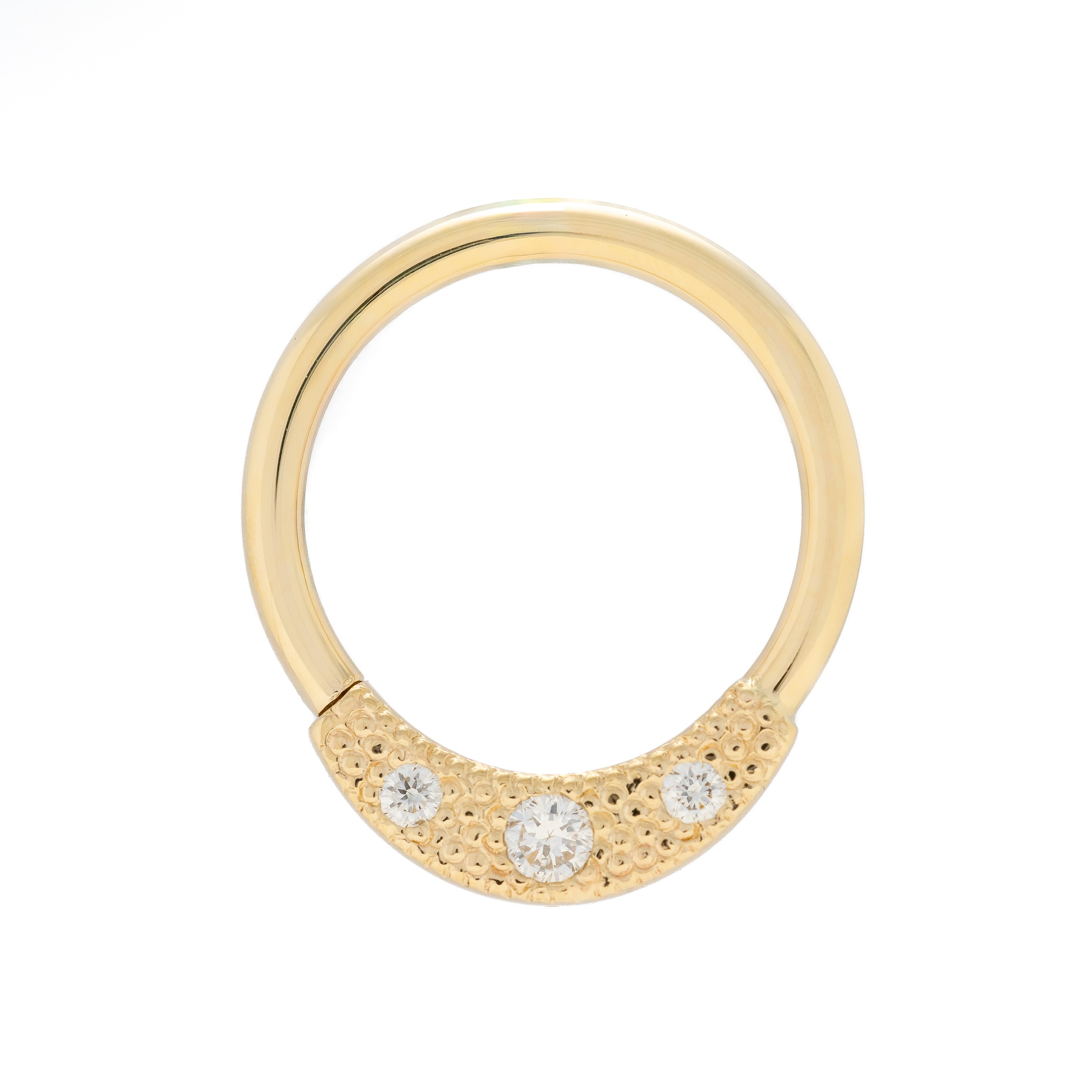 Gold ring with three small diamonds on a white background