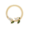 Gold ring with green gemstones on a white background