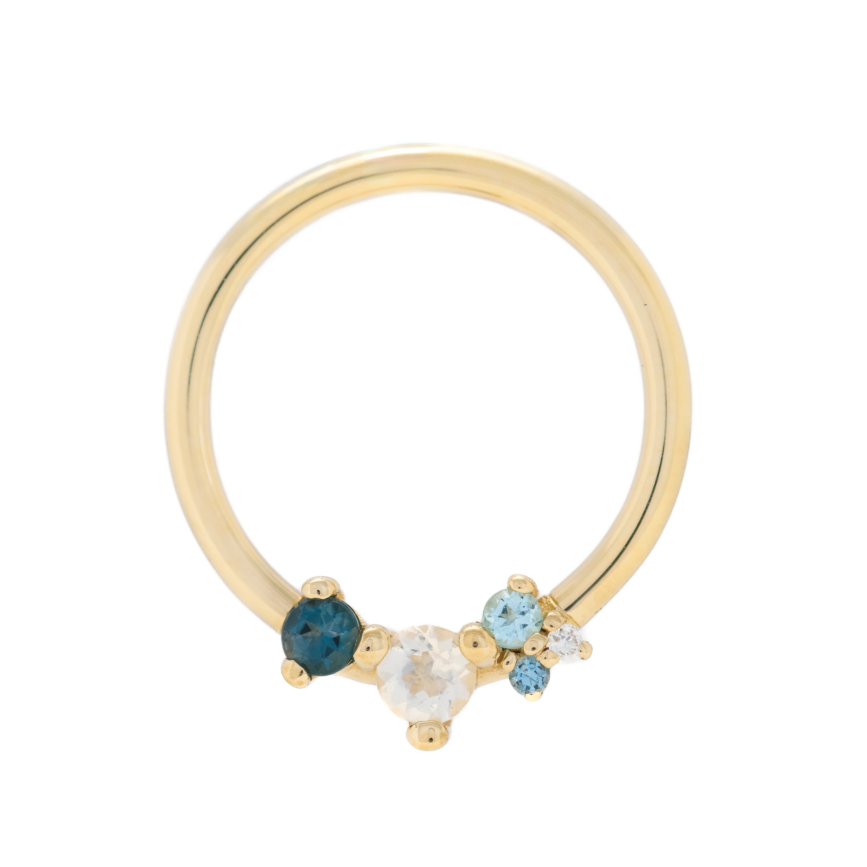 Gold ring with blue and clear gemstones on a white background