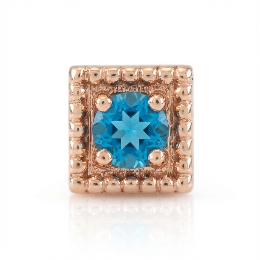 Rose gold end with a blue gemstone on a white background