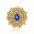 Gold earring with a blue gemstone on a white background