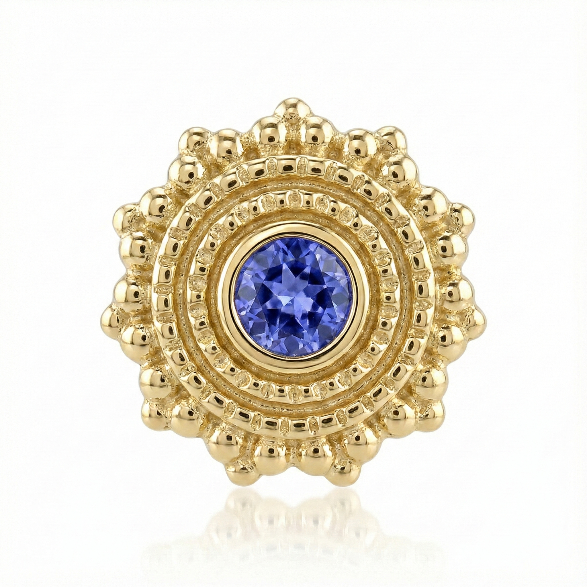 Gold earring with a blue gemstone on a white background