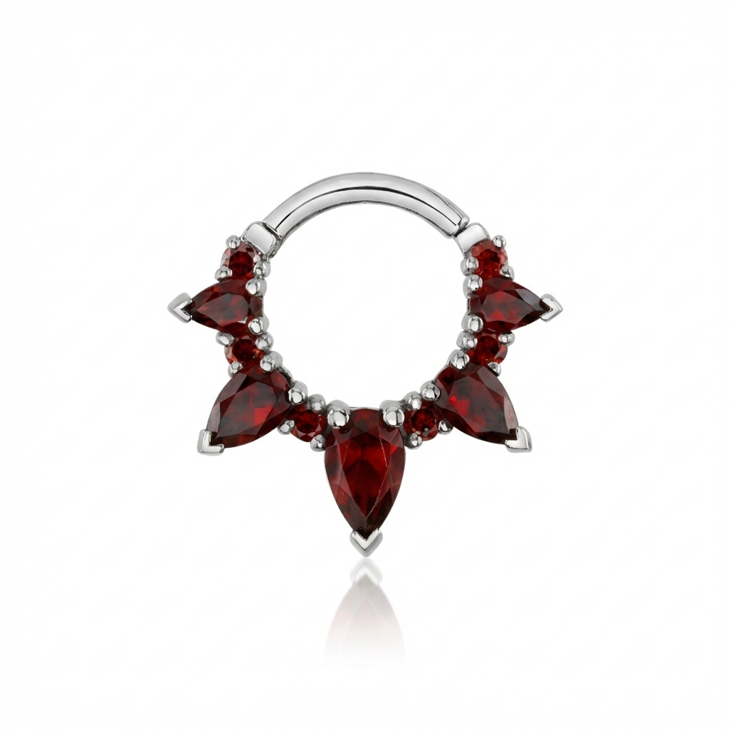 Silver nose ring with red gemstones on a white background