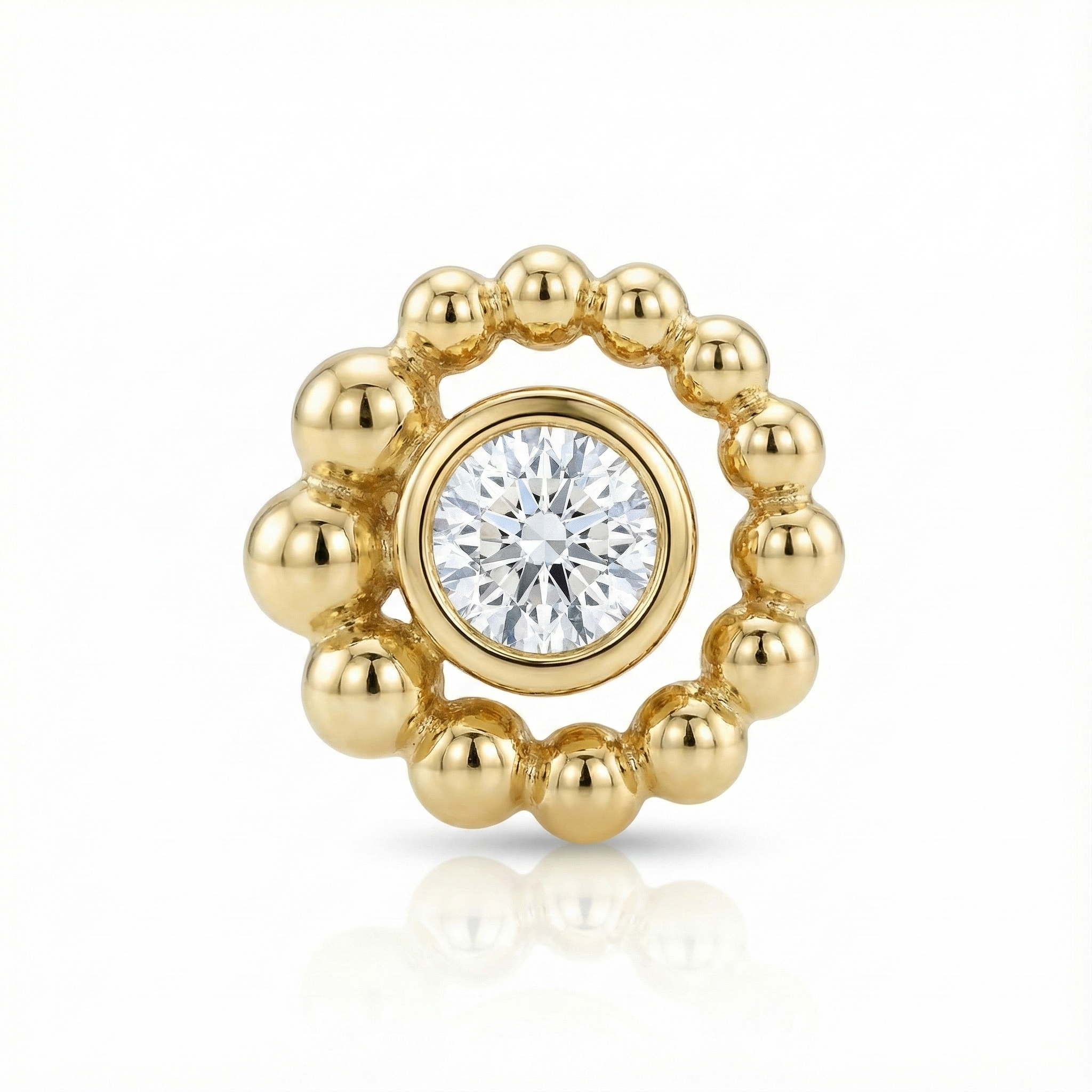 Gold earring with a central diamond on a white background